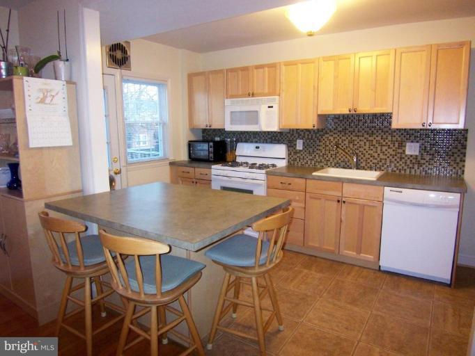331 Stratford Road Catonsville, MD 21228 - Photo 10 of 30 a kitchen with a table chairs sink and cabinets