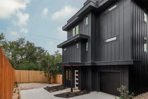 a building with a window and wooden fence