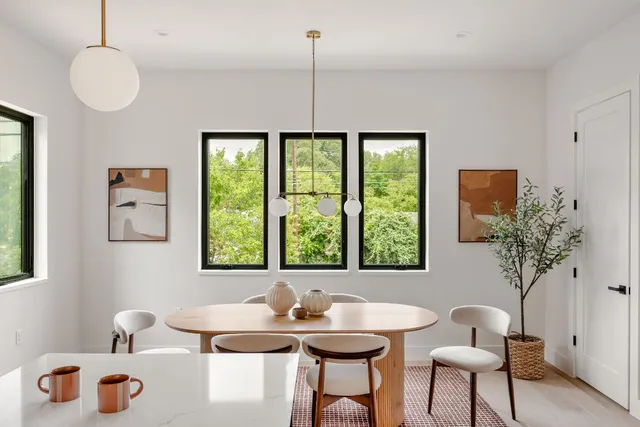 a kitchen with a sink cabinets and chairs
