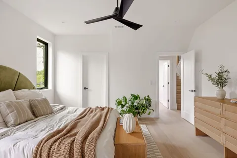 a bedroom with a bed couch and a window