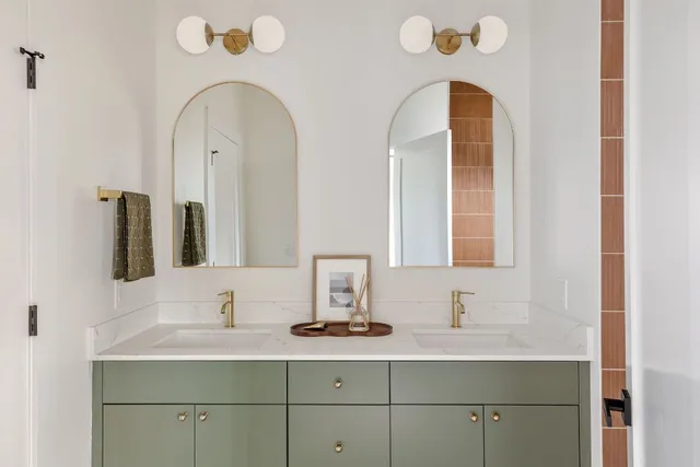 a bedroom with a bed and a potted plant