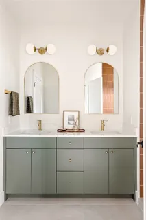 a bathroom with a double vanity sink and mirror