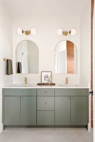 a bathroom with a double vanity sink and mirror