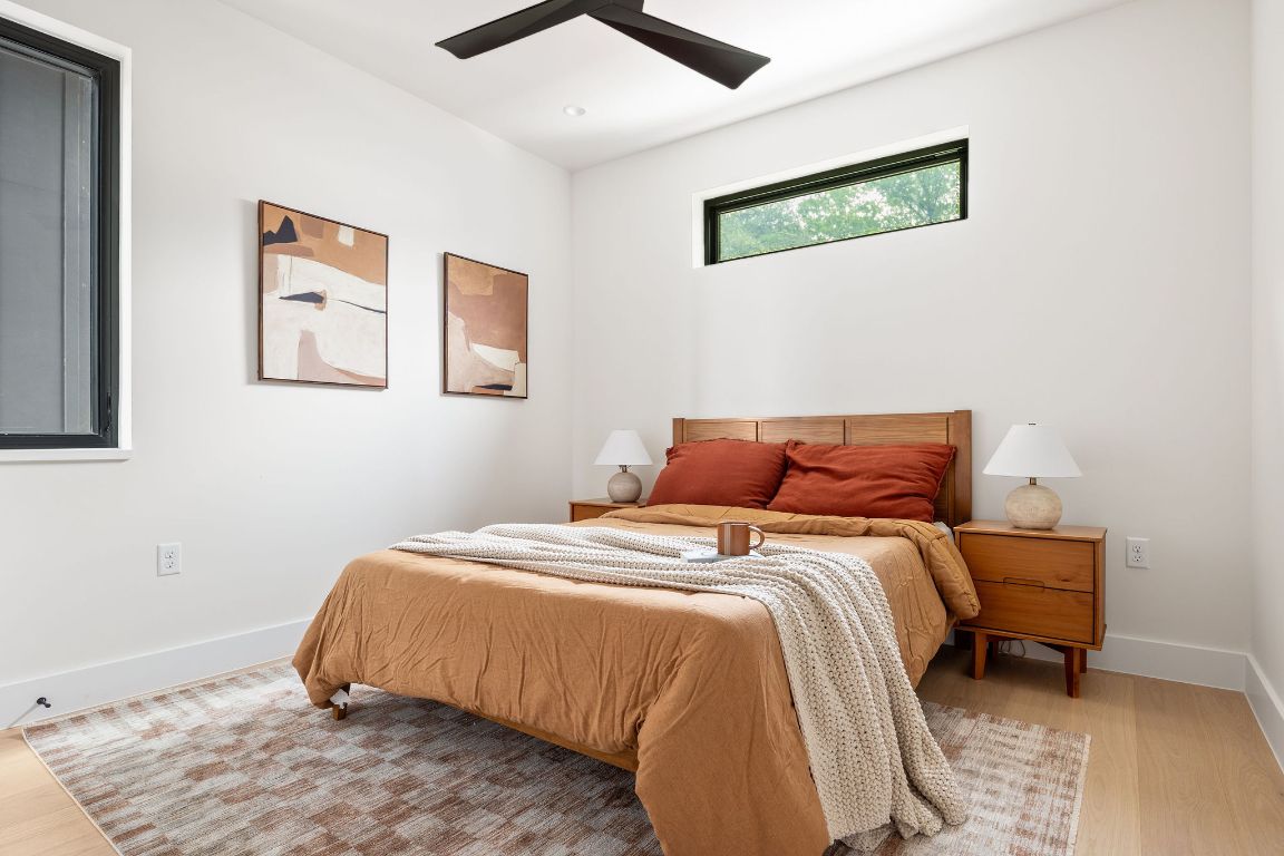 505 Philco Drive, Unit 3 Austin, TX 78745 - Photo 22 of 36 a bed sitting in a bedroom next to a window