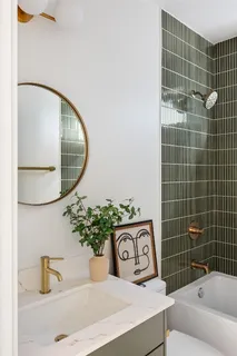 a bedroom with a bed and painting on the wall