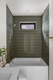 a bathroom with a sink a mirror and a shower