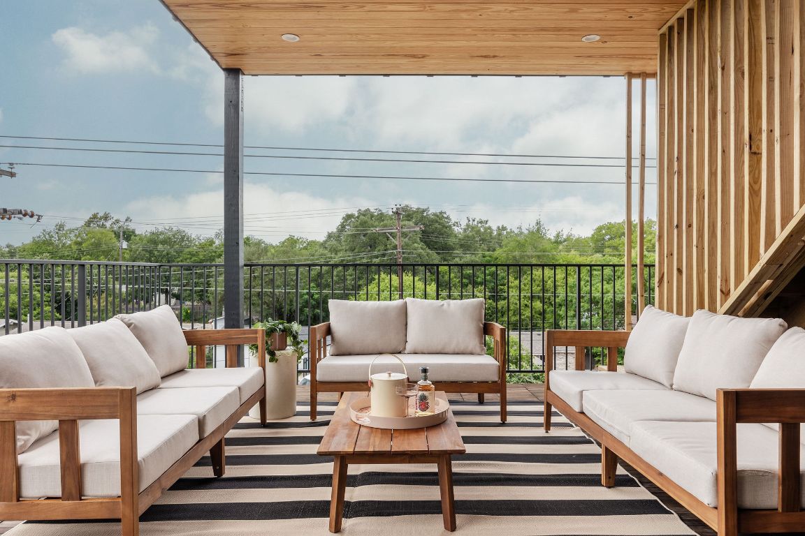 505 Philco Drive, Unit 3 Austin, TX 78745 - Photo 30 of 36 a view of a patio with couches chairs and wooden floor
