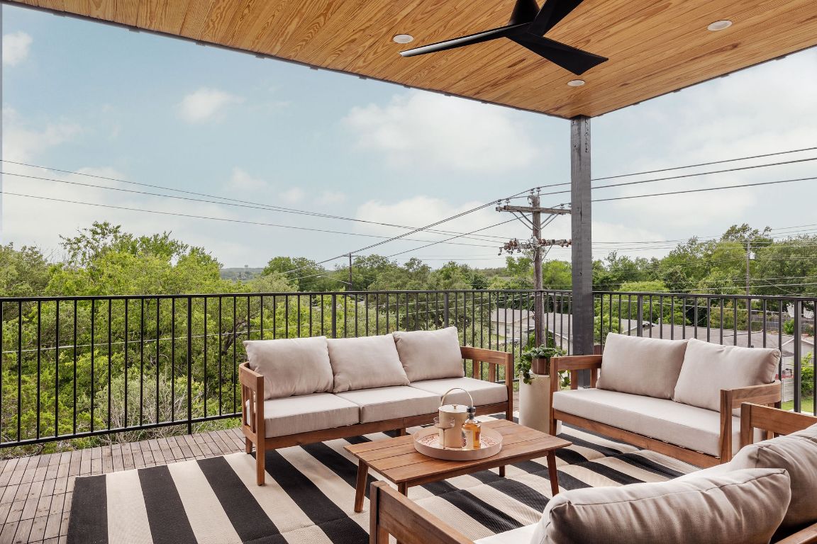 505 Philco Drive, Unit 3 Austin, TX 78745 - Photo 31 of 36 a balcony with furniture and a floor to ceiling window