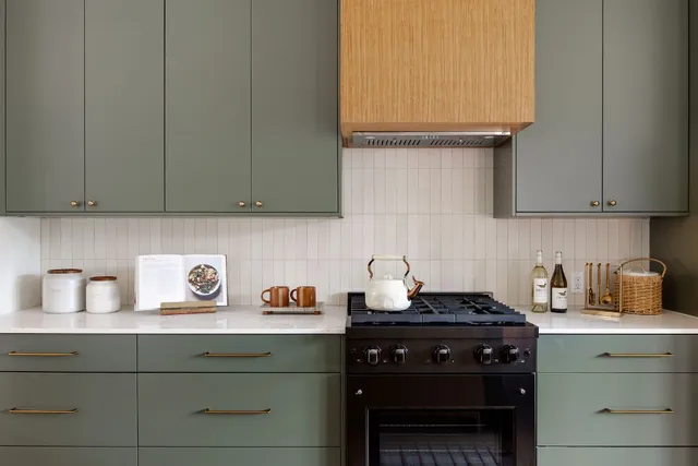 a kitchen with a stove and cabinets