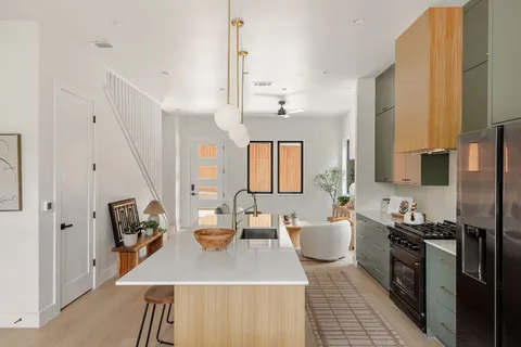 a kitchen with sink refrigerator and cabinets