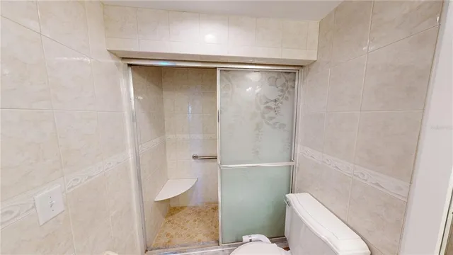a bathroom with a shower and toilet
