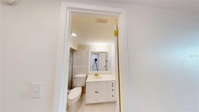 a bathroom with a toilet sink and a mirror