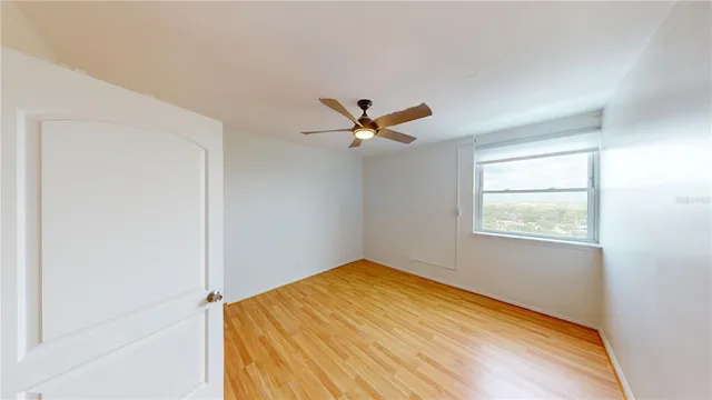 a bedroom with a bed and ceiling fan