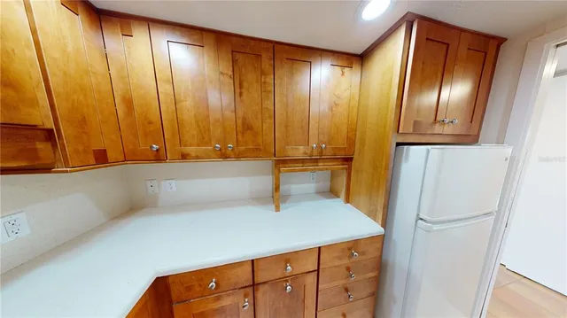 a hallway with sliding door and wooden cabinets