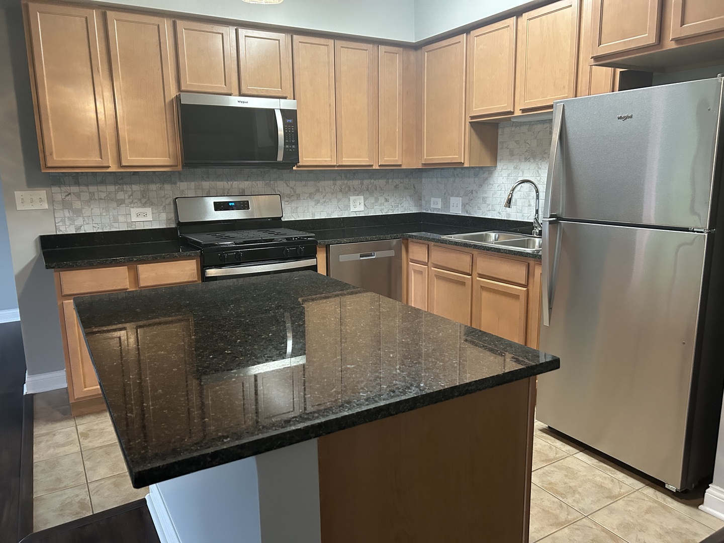 3400 North Old Arlington Heights Road, Unit 306 Arlington Heights, IL 60004 - Photo 2 of 10 a kitchen with granite countertop stainless steel appliances and wooden cabinets