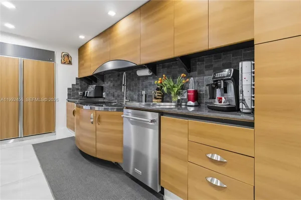 a kitchen with stainless steel appliances granite countertop a sink and cabinets