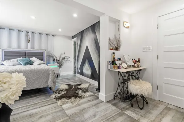 a bedroom with furniture and a window