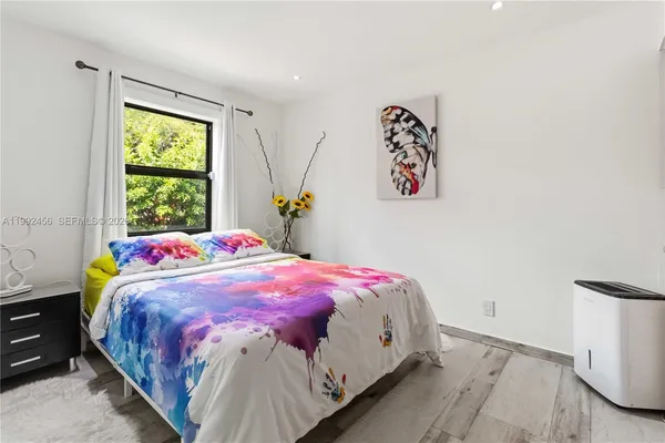 a bedroom with a bed and a window