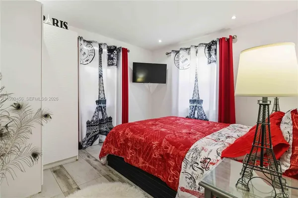 a bedroom with a bed and a flat screen tv