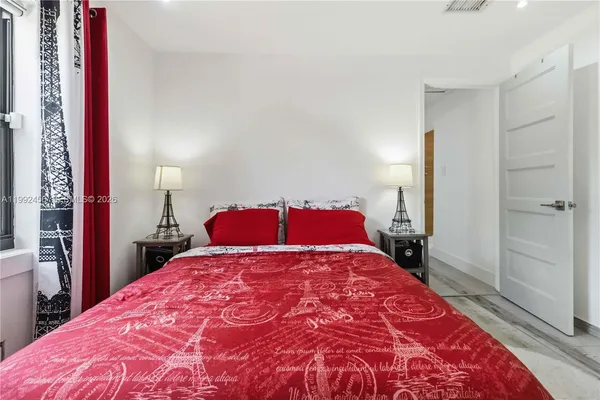 a bedroom with a large bed and a closet