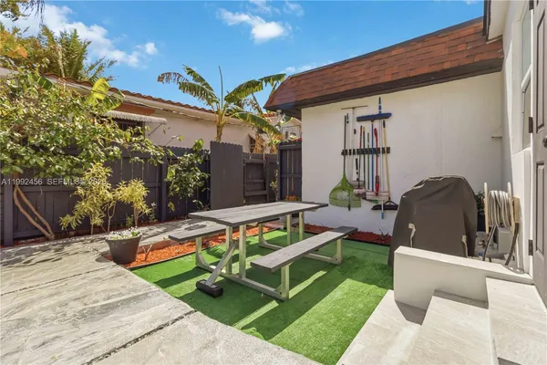 a view of an house with backyard and patio