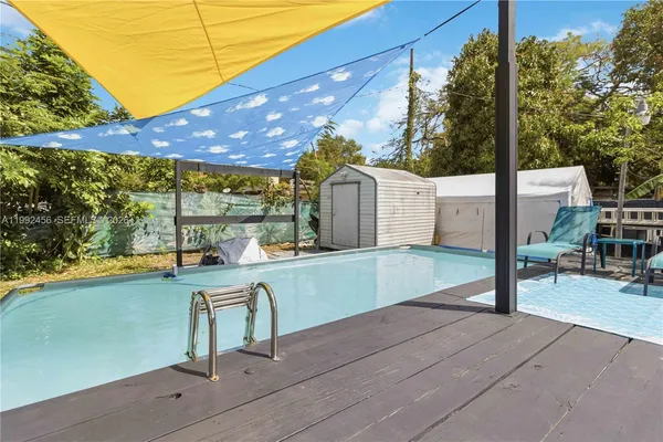 a view of a backyard with sitting area