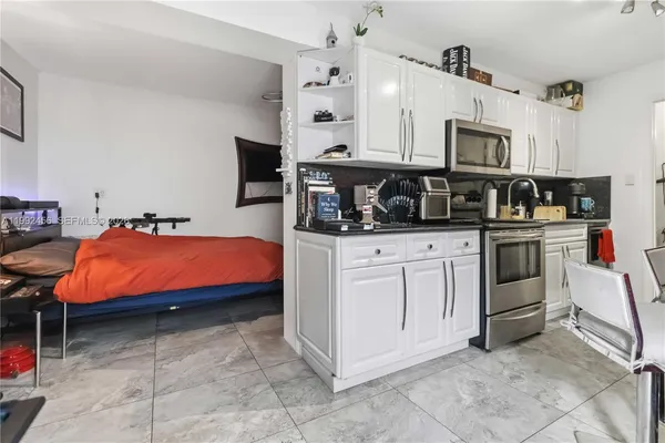 a bedroom with furniture and flat screen tv
