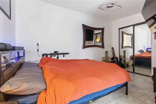 a bed room with a bed and two couches chair
