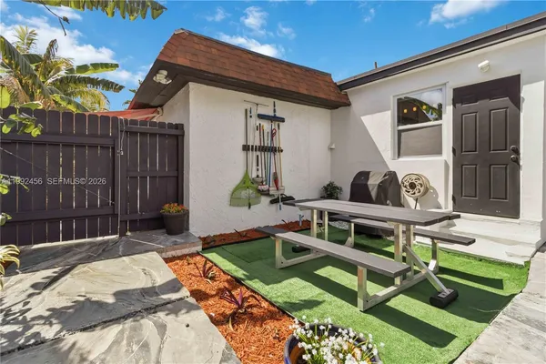 a view of backyard with a patio and outdoor seating