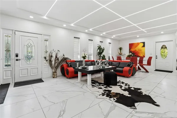 a living room with furniture a rug and white walls