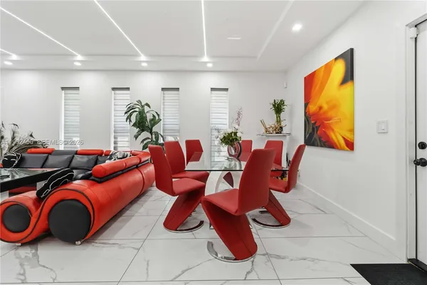 a living room with furniture a rug and white walls