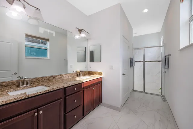 a bathroom with a glass shower door