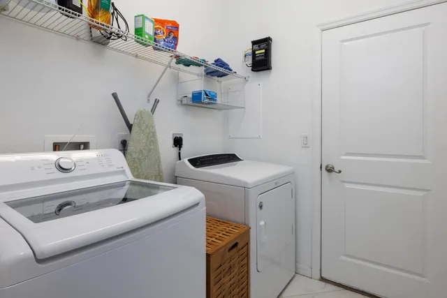 an empty room with chandelier fan