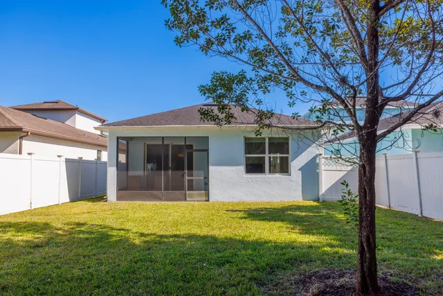 a view of a house with a backyard