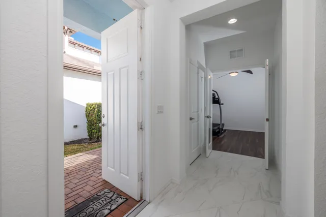 a kitchen with stainless steel appliances granite countertop a stove top oven a sink a dining table and chairs