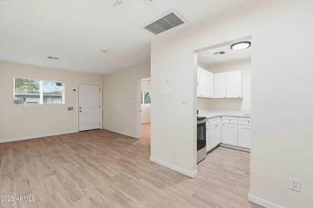 a view of a kitchen with wooden floor and a sink