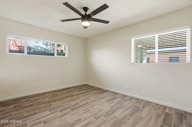 wooden floor in an empty room with a window