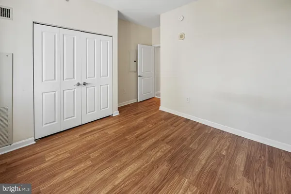 a view of a room with wooden floor and entryway