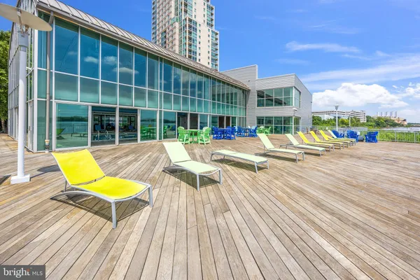 a view of swimming pool with lounge chair and dinning table under an umbrella