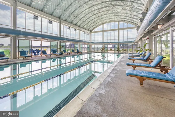a view of a swimming pool with outdoor seating