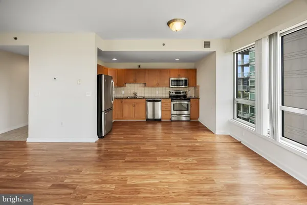 a view of a kitchen with a sink and a large window