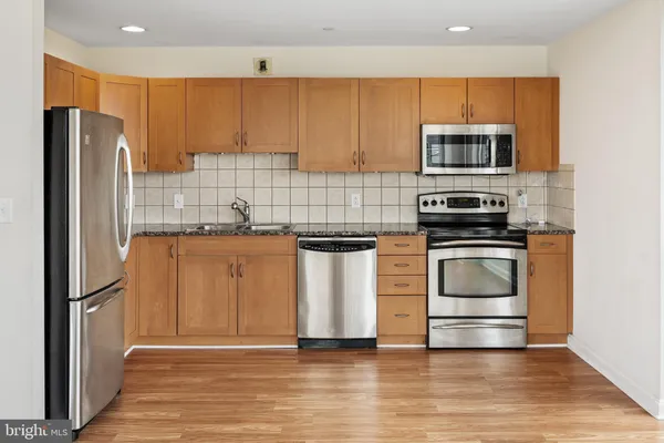 a kitchen with stainless steel appliances a refrigerator stove and microwave
