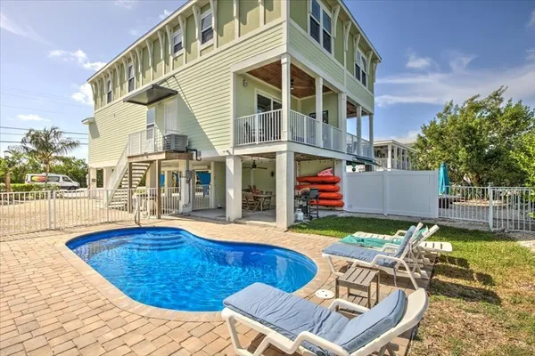 a view of a house with swimming pool and sitting area