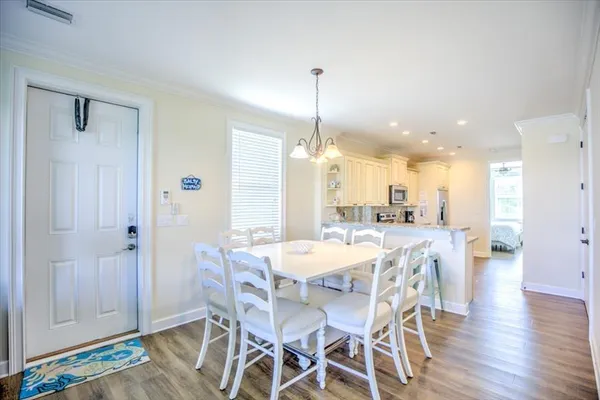 a dining area with a table and chairs