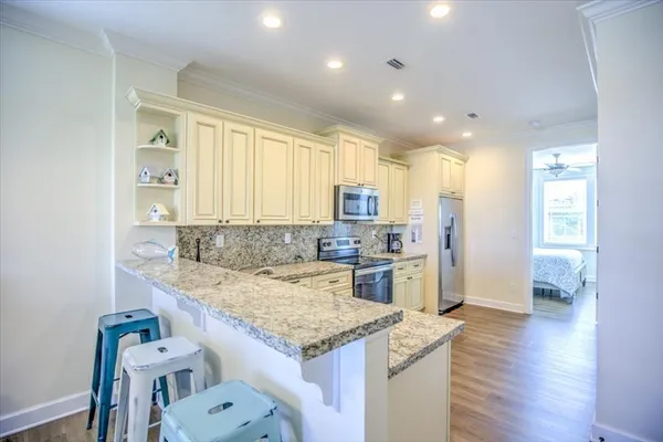 a kitchen with a stove a refrigerator and a sink