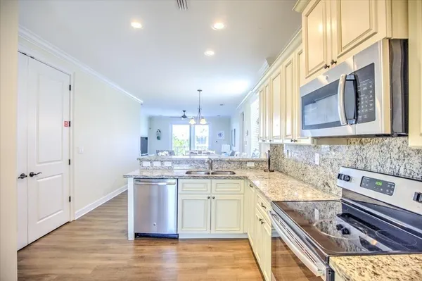 a kitchen with a sink stove and cabinets
