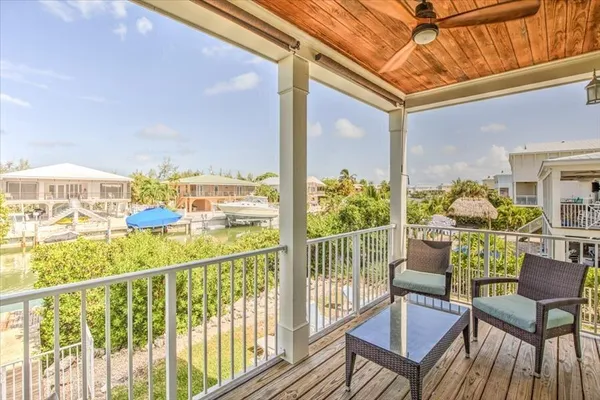 a view of a chairs and table on the balcony