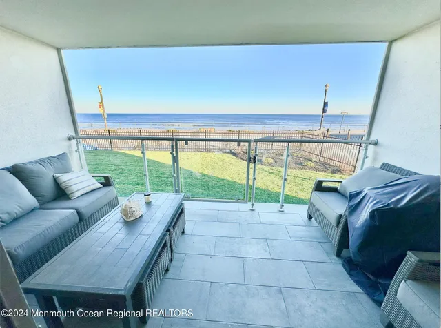 a living room with furniture and a floor to ceiling window
