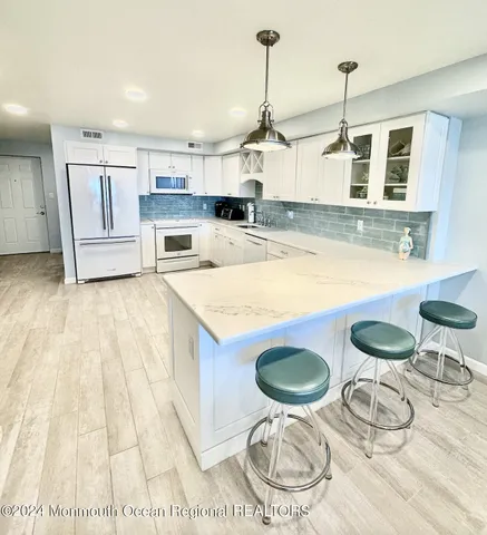 a kitchen with a table and chairs