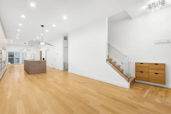 a view of a kitchen with furniture and a ceiling fan